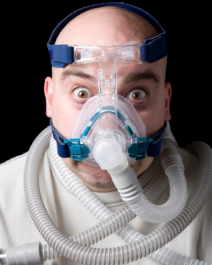 Man Having CPAP Mask difficulties