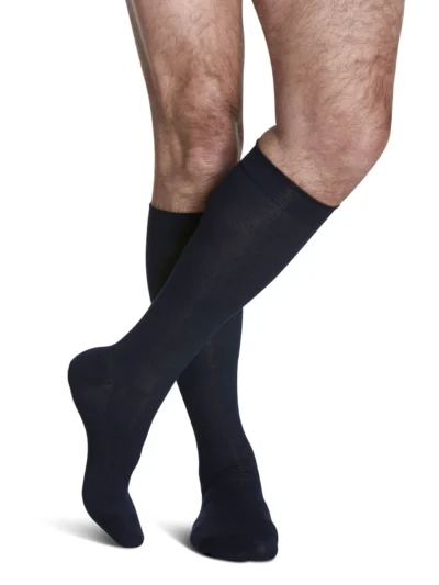 Man wearing Sea Island Cotton compression socks with crossed legs in Navy color