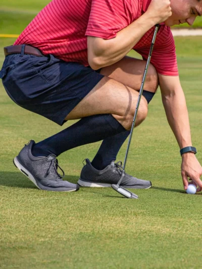 Man golfing while wearing Sigvaris Sea Island Cotton Compression Socks